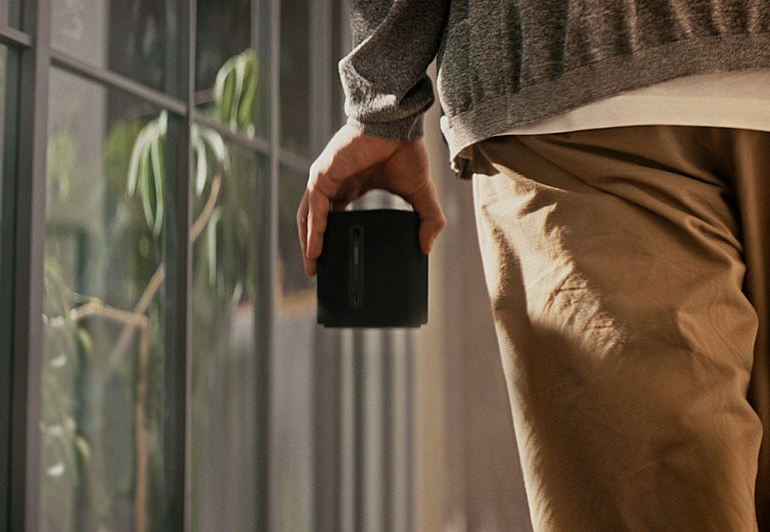 Image of a man holding the Yamaha TRUE X SPEAKER 1A