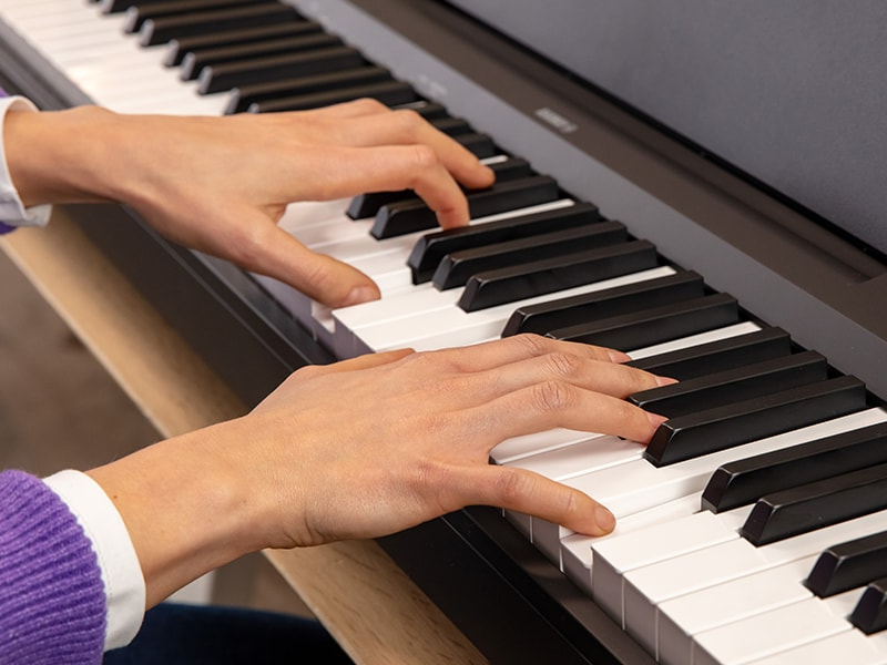 The hands of a person playing the P-145